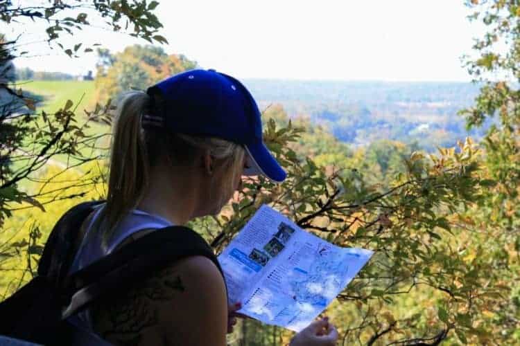 woman reading a map during a hike