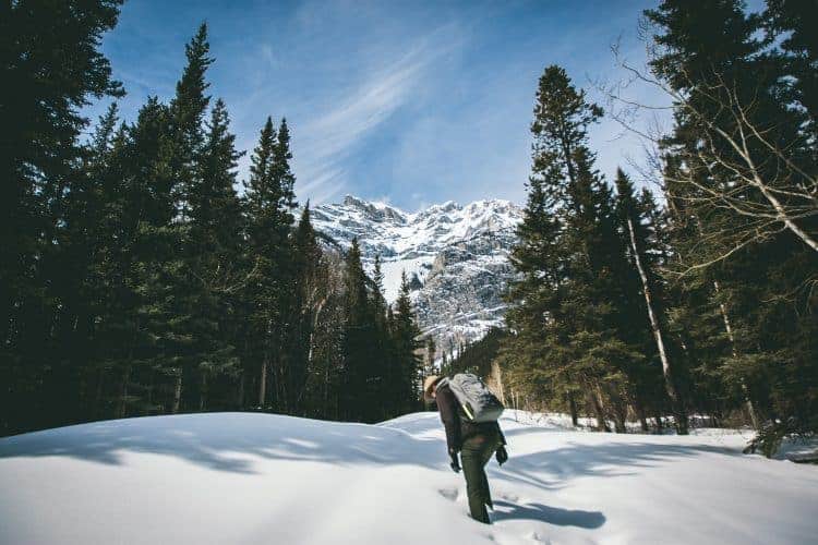 a hiker walking in the snow