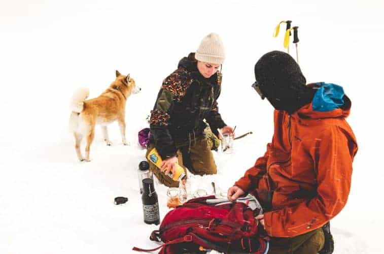 a couple eating in the snow