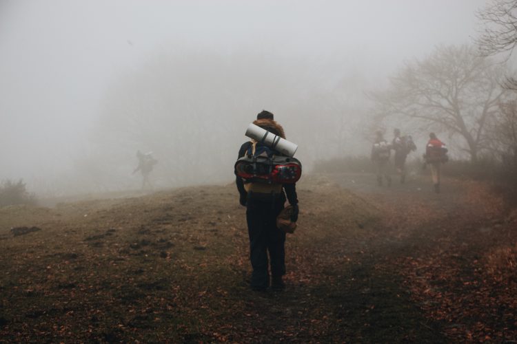 man hiking in the fog