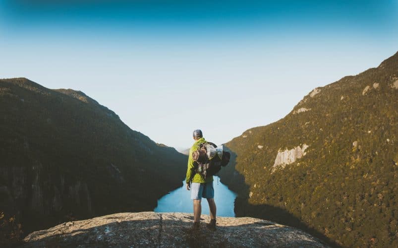 man hiking with a yellow jacket