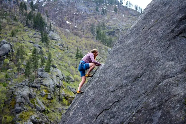 man climbing a rock