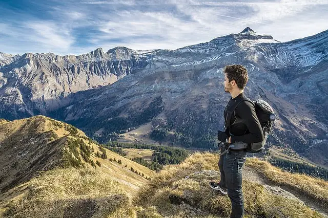 man standing on a hill