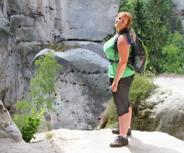 a woman standing on a rock