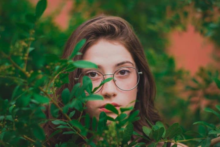 a girl wearing spectacles in nature
