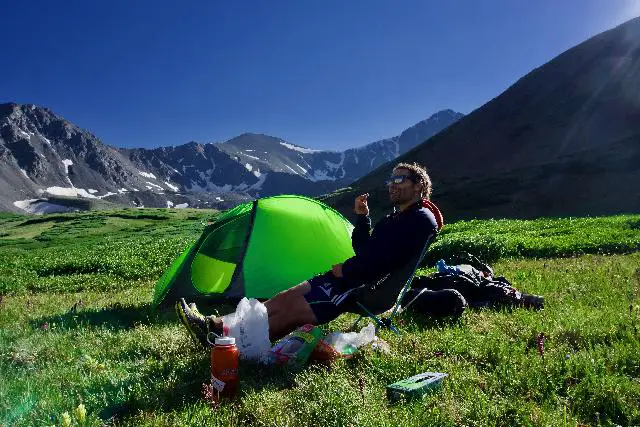 a hiker chills near his tent