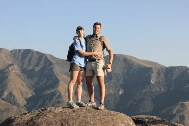 couple standing on a rock