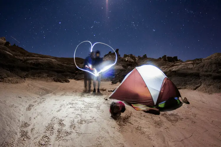 a couple camping with a tent