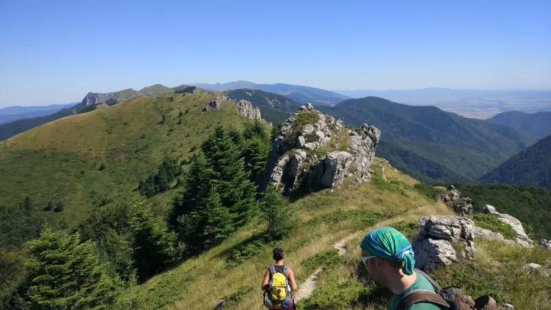 two men walking on a steep hill