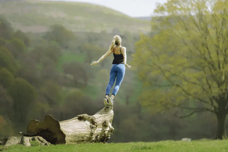 woman jumping off a tree