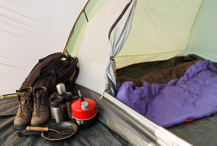 a camping tent with hiking gear inside