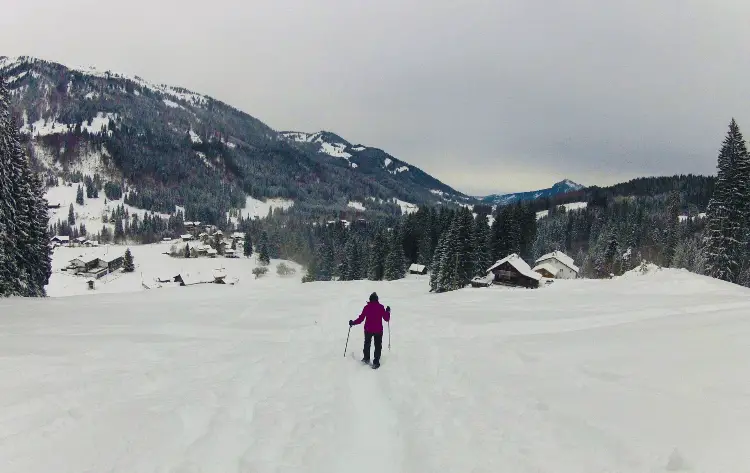 man backpacking in winter