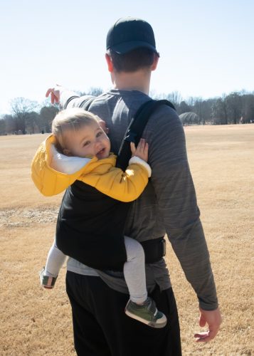 a hiking dad with his baby in the co carrier