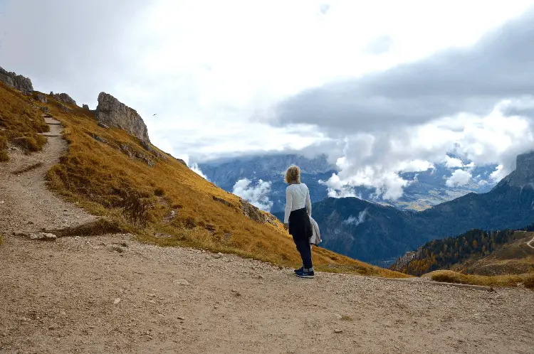 a woman looking at a stunning mountain view