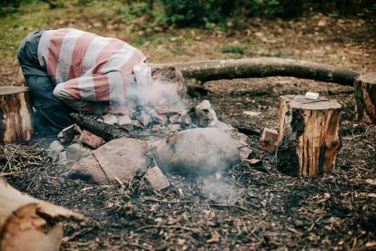 blowing a campfire