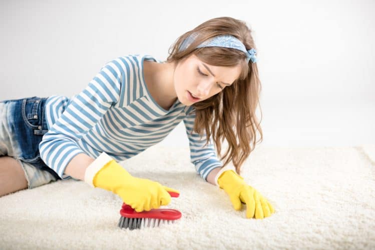 a girl cleaning a tent carpet