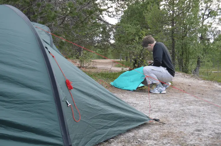 a man folding a tent