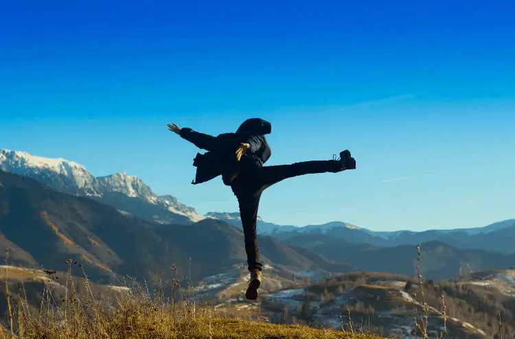 a hiker in the mountains posing