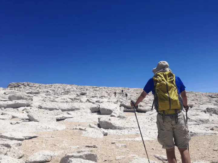 a hiker with a yellow backpack