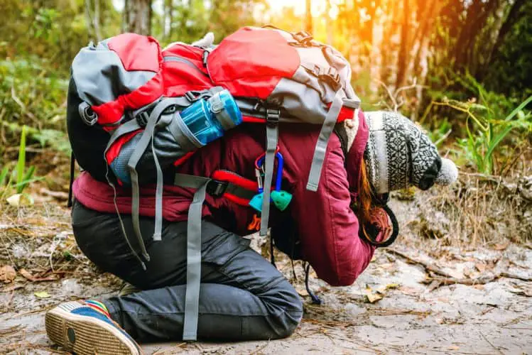 a man wearing a hiking pack with a lot of straps