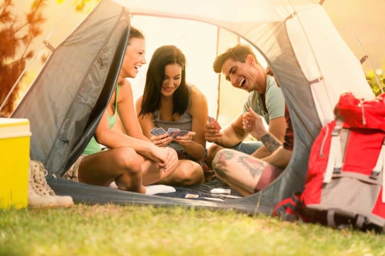 friends playing camping games in the tent