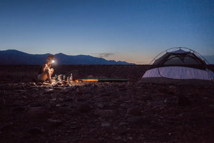 woman camping in the dark