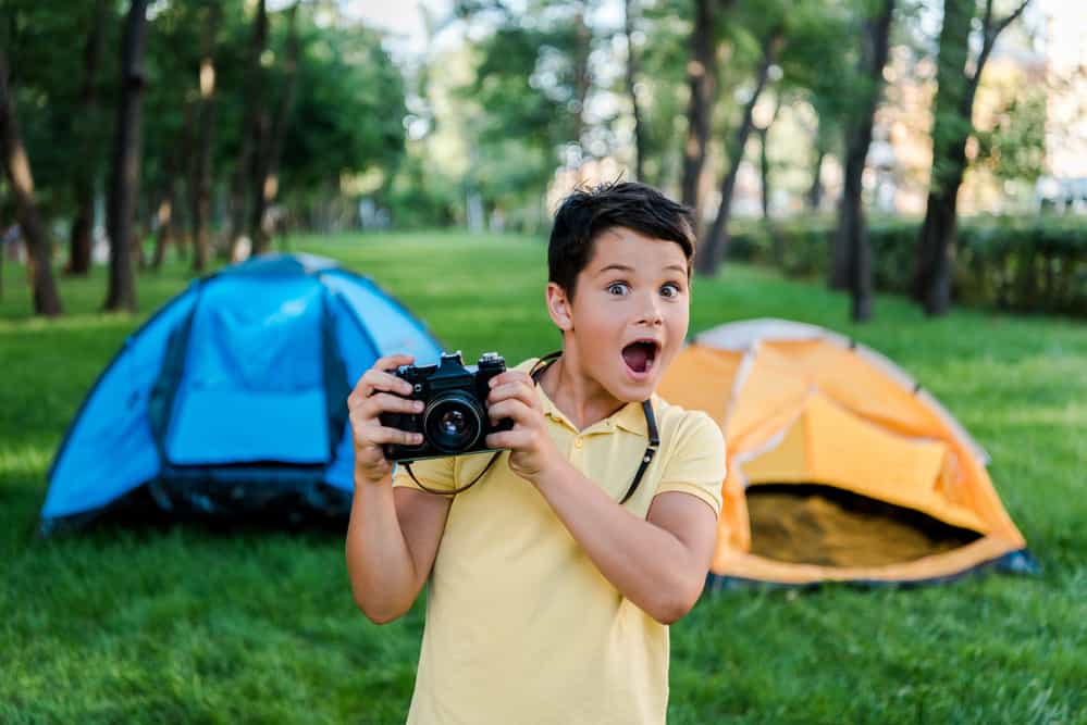 a boy camping in a tent