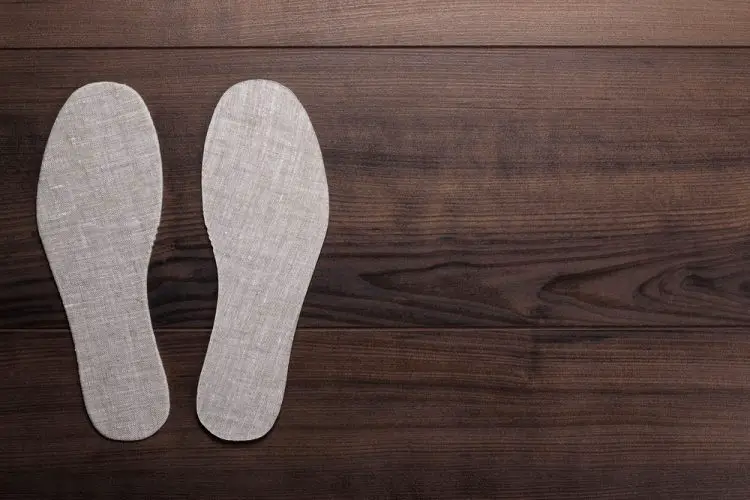 insoles for shoes on wooden background