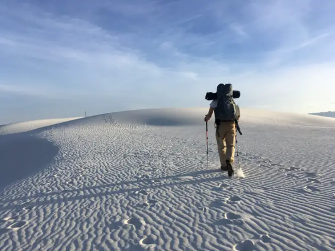a man walking through the desert